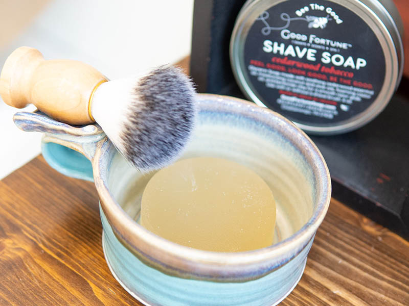 Shaving soap bar in a mug with shaving brush