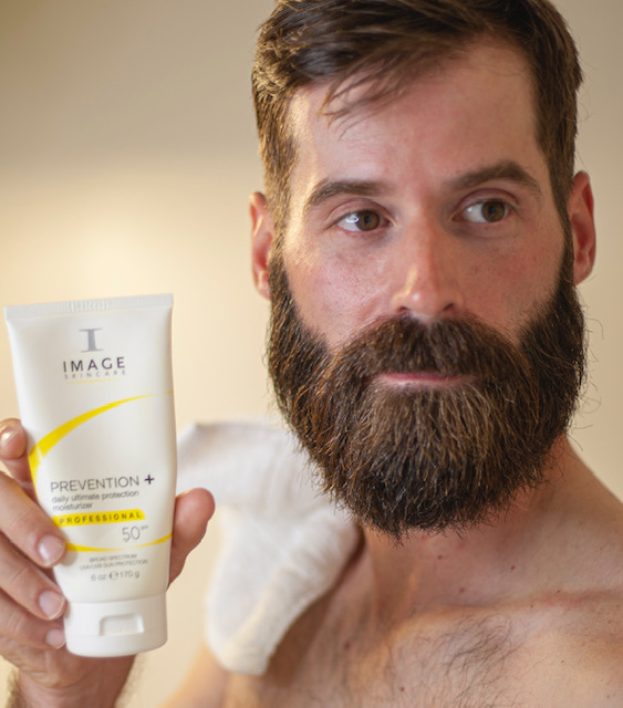 Man using Image Skincare's moisturizer sunscreen