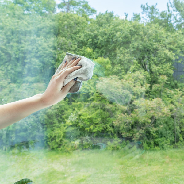 Cleaning a Window with All Natural Ammonia Free Window Cleaner using essential oils.