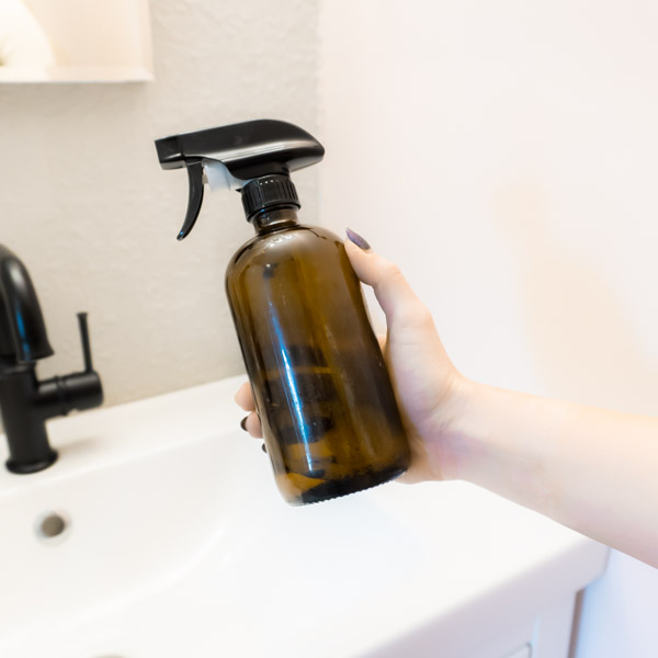 All Natural Cleaning Solution in a Glass Spray Bottle for cleaning surfaces in the bathroom and kitchen