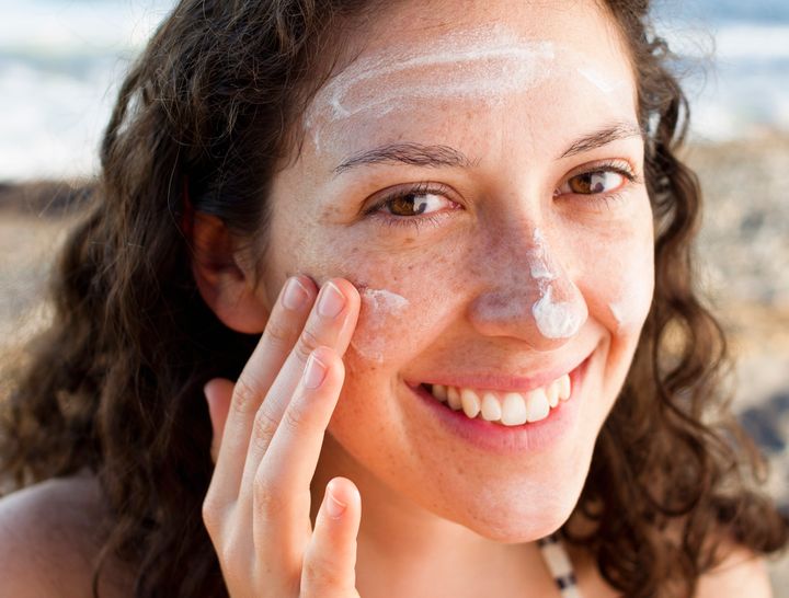 Woman applying sunscreen